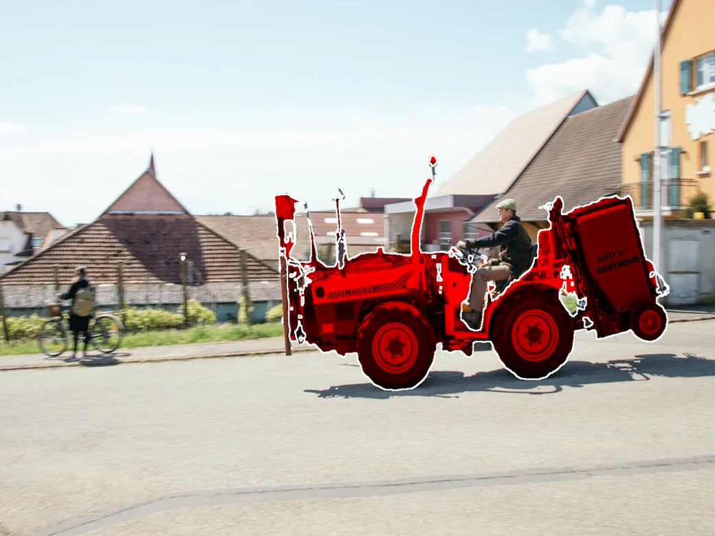 Maskomaly highlights an anomalous forklift in red on a street